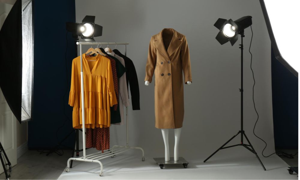 Ghost mannequin clothes and professional lighting equipment in modern photo studio