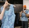 Man Taking Picture of a Dress in a clothing shop