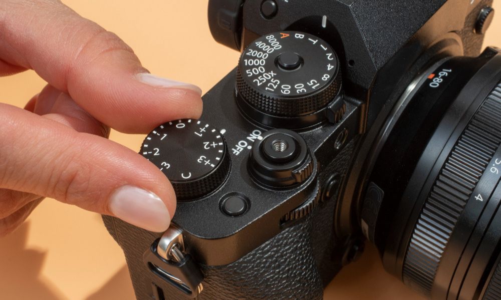 High angle hands holding digital photo camera