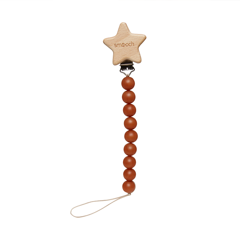 A wooden pacifier clip with a star-shaped top, featuring the word "smooch" engraved on it