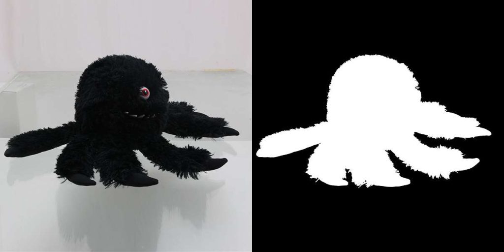 A black plush spider toy on a reflective surface on the left, and its white silhouette on a black background on the right, demonstrating alpha channel masking