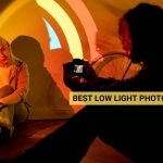 Photographer capturing photos of woman in low light