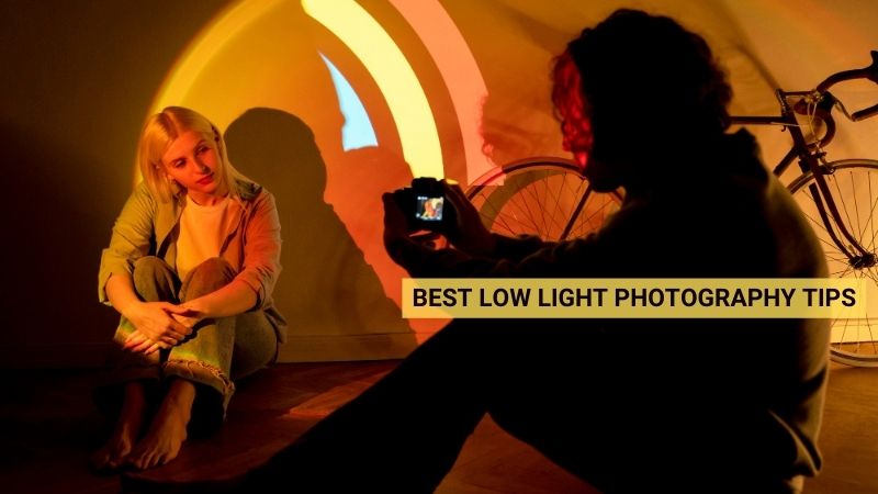 Photographer capturing photos of woman in low light