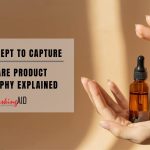 hands gently holding an amber dropper bottle under warm lighting