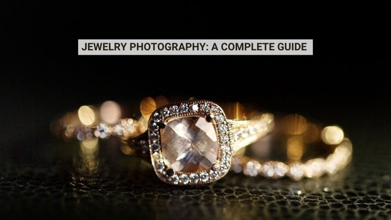 Close-up of two sparkling gold rings with diamonds on a dark surface