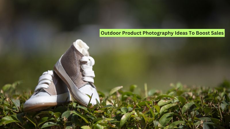 Child's gray and white high-top sneakers on green foliage outdoors