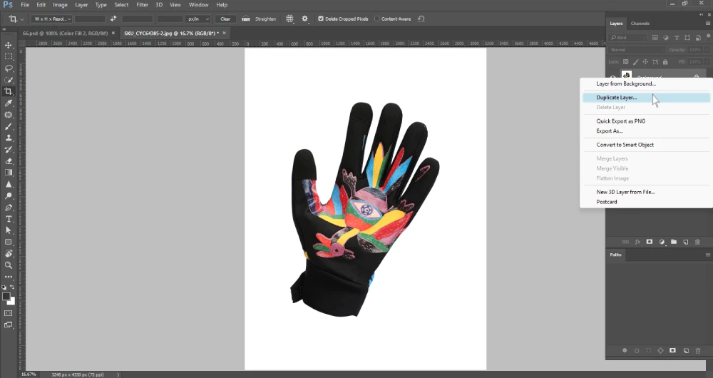 A Photoshop screenshot displays a vibrant black and colorful cycling glove on a white background. A contextual menu on the right, originating from the Layers panel, is open with "Duplicate Layer..." highlighted. The layers panel shows a single "Background" layer