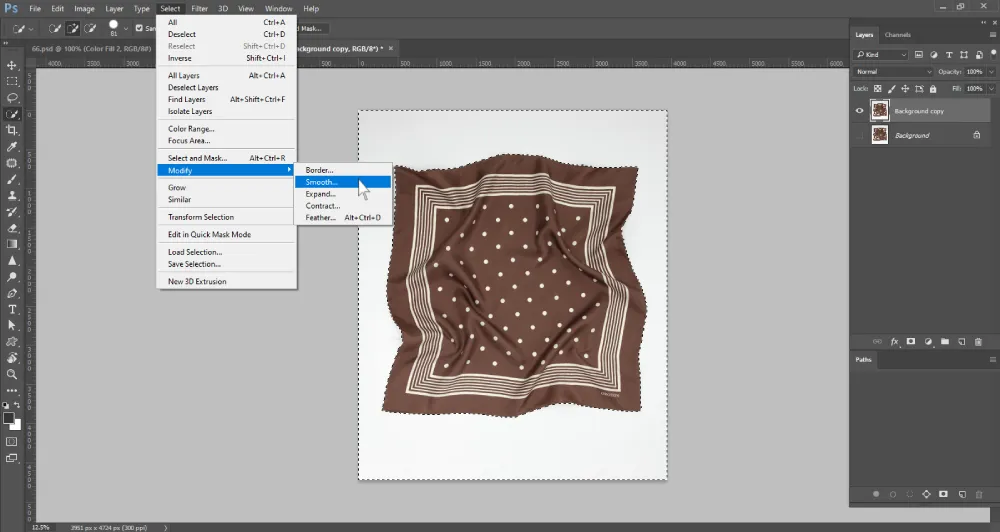 Screenshot of Adobe Photoshop with a brown polka-dotted scarf on a white background. A selection surrounds the background area, and the top menu shows the "Select" dropdown expanded