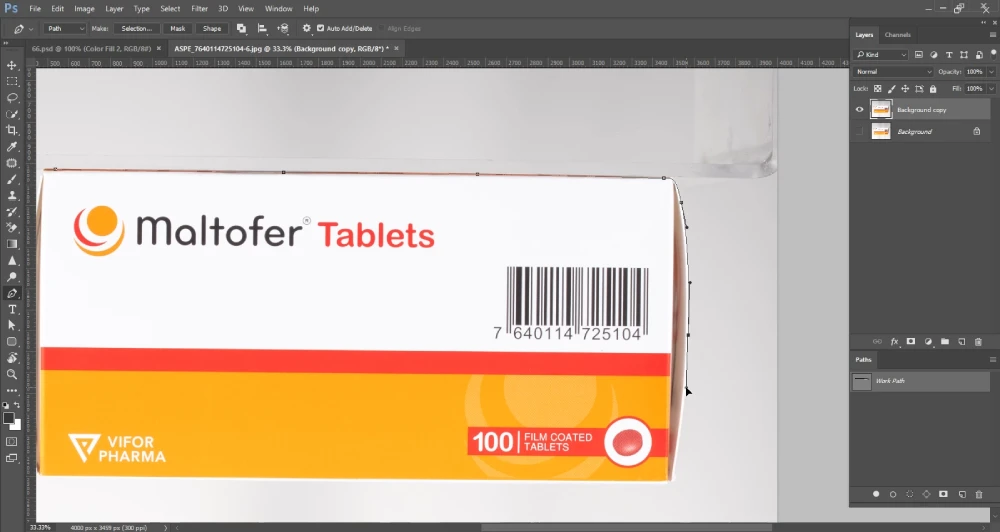 A Photoshop screenshot shows a close-up of a white and orange box of "Maltofer Tablets" with a barcode. A path is being drawn around the top and right edges of the box using the Pen Tool, indicated by anchor points and bezier curves. The "Paths" panel on the right shows "Work Path" listed, and the layers panel shows "Background copy" and "Background" layers