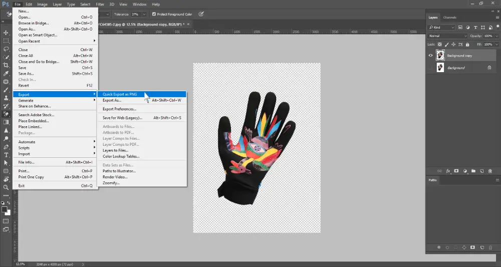 A Photoshop screenshot displays a black cycling glove with a vibrant, colorful design on the palm, now fully isolated on a transparent background, indicated by a checkerboard pattern. A dropdown menu is open from the "File" menu, with "Export" highlighted. A sub-menu to the right of "Export" is also open, with "Quick Export as PNG" highlighted. The layers panel on the right shows "Background copy" and "Background" layers