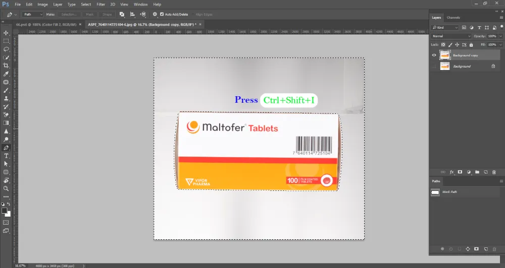 A Photoshop screenshot displays a white and orange box of "Maltofer Tablets" with a barcode, now enclosed by a dotted selection outline (marching ants). An instruction "Press Ctrl+Shift+I" is overlaid in blue and green text above the box. The "Paths" panel on the right shows "Work Path" listed, and the layers panel shows "Background copy" and "Background" layers