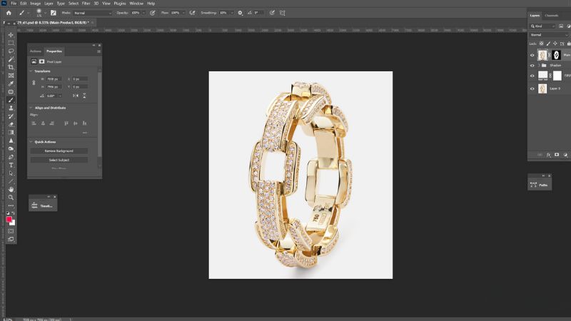 Gold bracelet being edited in Adobe Photoshop for jewelry photo retouching