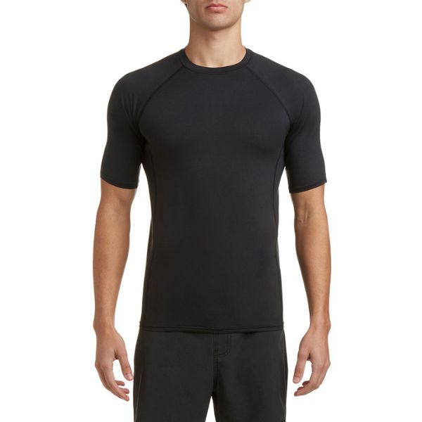 A person wearing a plain black short-sleeved top and black shorts stands against a white background.