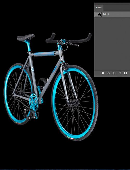 A grey and blue fixed-gear bicycle with bright blue rims and components is set against a black background