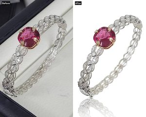 Before and after image showing jewelry photo retouching of a silver bracelet with a red gemstone; the "Before" side has a dull background and shadows, while the "After" side features a clean white background, enhanced shine, and improved gemstone color
