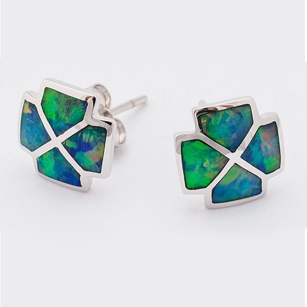 A pair of silver stud earrings with a cross-like shape, each featuring four trapezoidal segments of iridescent blue and green opal.