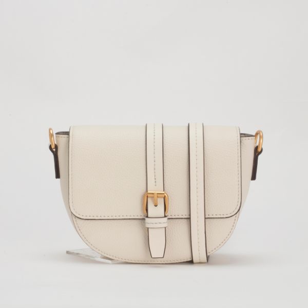 An off-white or cream-colored leather saddle bag with a gold buckle and thin strap is displayed on a plain grey background, propped up by a small, clear stand