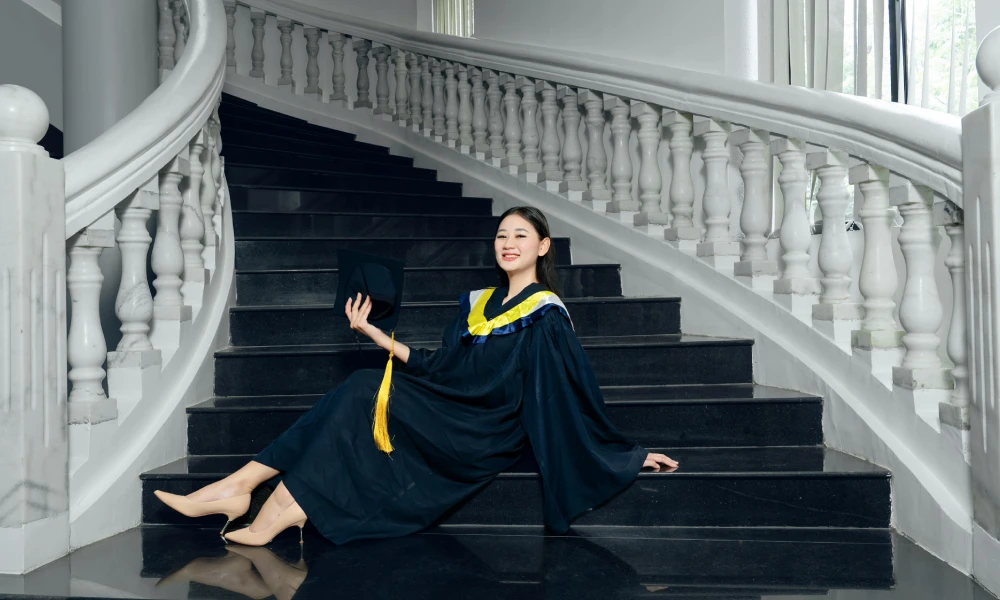 A Graduate sitting on stairs