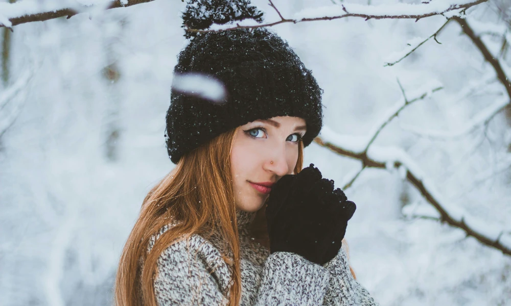 Woman in warm clothes in snow